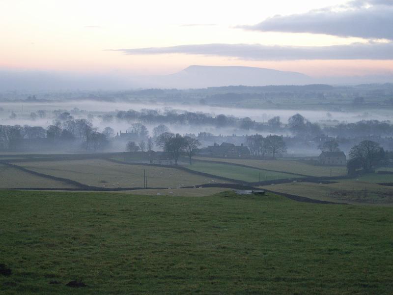 0712lv 133.jpg - "Fog" - by Louise Vardey Long Preston in fog from New Pasture The School is in the centre with Pendle in the background.